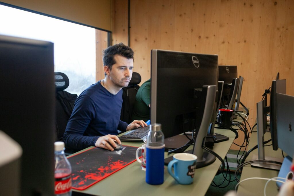 a man sitting at a desk using a computer