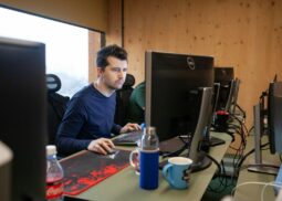 a man sitting at a desk using a computer