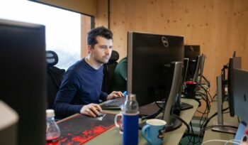 a man sitting at a desk using a computer