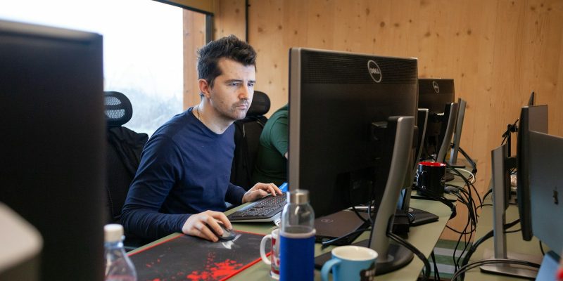 a man sitting at a desk using a computer